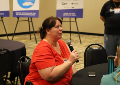 Participant asks a question into the microphone as she is attends Ollie Cantos's session at the 2019 SOAR Conference.