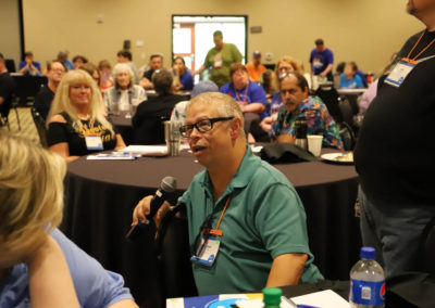 Participant from Missouri asks a question into the microphone as he is attends Ollie Cantos's session at the 2019 SOAR Conference.