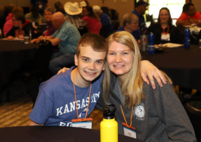 Participants from Kansas sit next to one another and pose for a photo at the 2019 SOAR conference