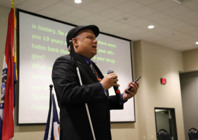 Ollie Cantos holds his phone and microphone as he gives his featured presentation at the 2019 SOAR Conference.