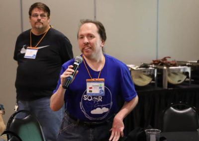Participant from Missouri asks a question into the microphone as he is attends Ollie Cantos's session at the 2019 SOAR Conference.