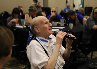 Participant from Iowa asks a question into the microphone as he is attends Ollie Cantos's session at the 2019 SOAR Conference.