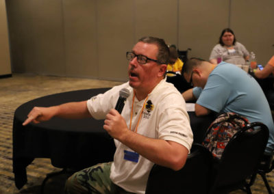 Participant from Kansas asks a question into the microphone as he is attends Ollie Cantos's session at the 2019 SOAR Conference.
