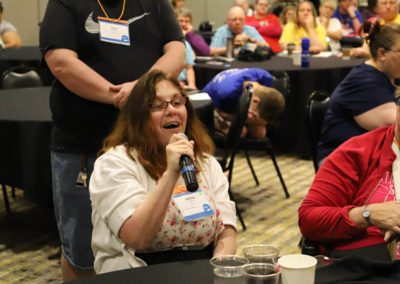 Participant from Missouri asks a question into the microphone as she is attends Ollie Cantos's session at the 2019 SOAR Conference.