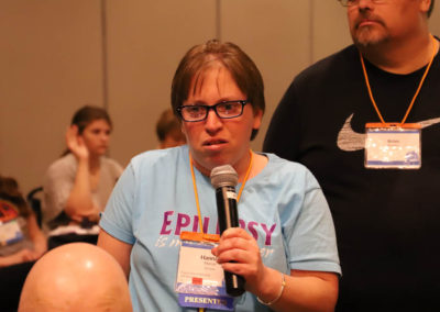 Participant from Nebraska asks a question into the microphone as she is attends Ollie Cantos's session at the 2019 SOAR Conference.