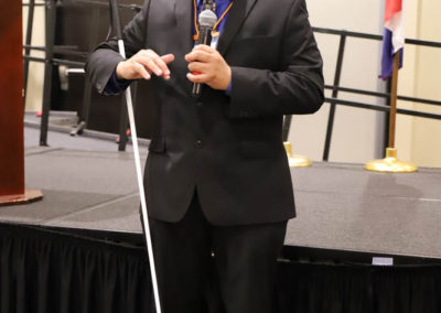 Ollie Cantos stands holding a microphone as he gives his presentation at the 2019 SOAR Conference.