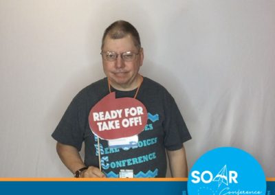 SOAR Conference participant smiles and poses for a selfie booth photo!