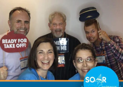 SOAR Conference participants smile and pose for a selfie booth photo!